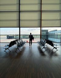 Rear view of man walking at airport