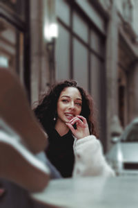 Portrait of a smiling young woman using smart phone