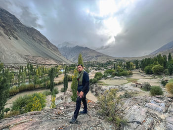 View of man walking on mountain in phander valley in pakistan against sky