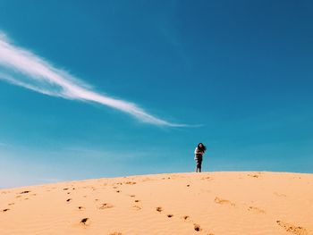 Rear view of a man standing in desert