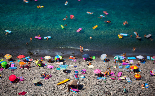 Close-up of people relaxing on beach