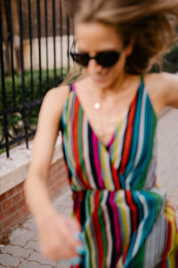 Rear view of young woman standing against wall