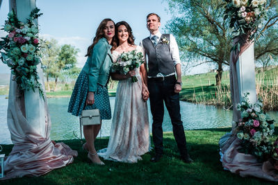 Full length portrait of friends standing at park