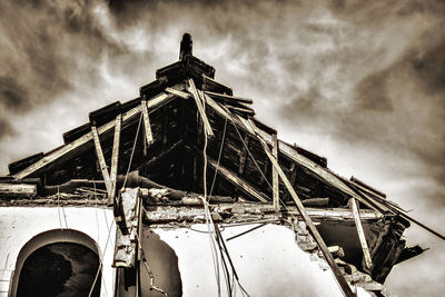 Low angle view of abandoned ship against sky