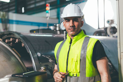 Portrait of man standing in factory