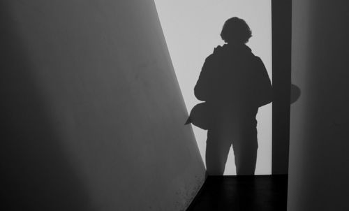 Silhouette of man standing in corridor