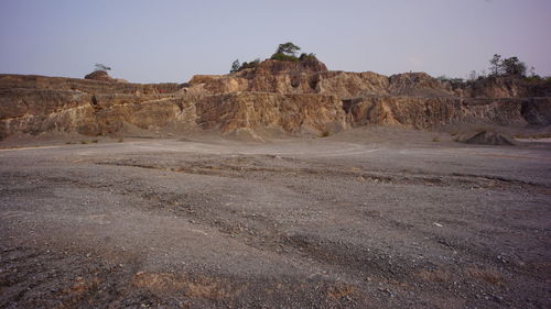 Rock formations on landscape against sky