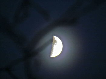 Low angle view of illuminated street light against sky