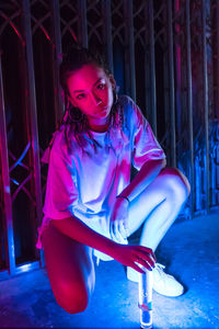 Portrait of young woman sitting outdoors
