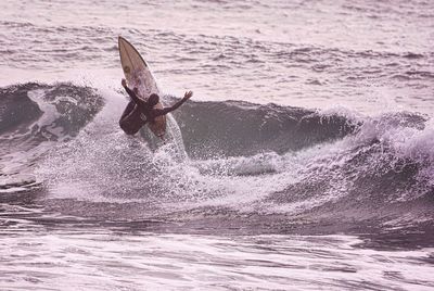 People surfing in sea