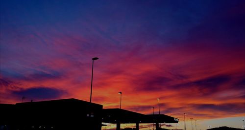 Low angle view of silhouette buildings against sky during sunset