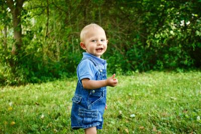 Portrait of cute boy smiling in grass