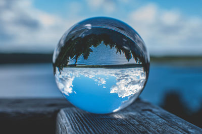 Close-up of crystal ball on wooden surface