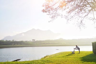 Man standing by lake against nice sky.inspiration go outdoor and exercise 