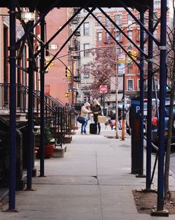 Woman walking on road in city