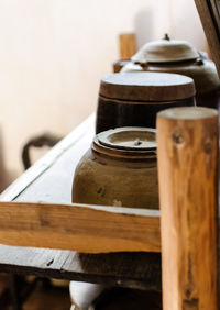 Antique containers on wooden shelf