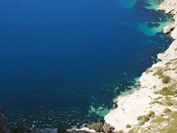 High angle view of rock formations by sea