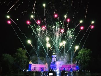 Low angle view of firework display at night