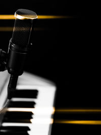 Close-up of piano keys against black background