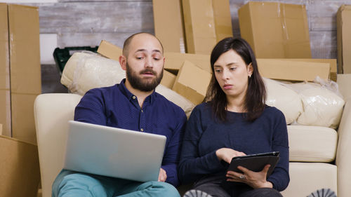 Portrait of young woman using laptop at home