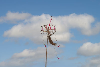 Low angle view of telephone pole against blue sky