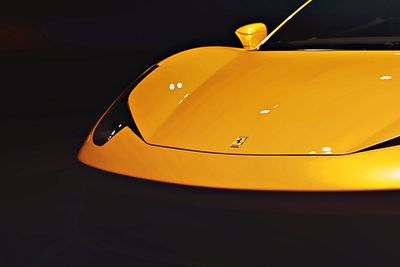 Close-up of yellow electric lamp against black background