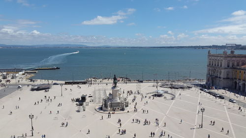 High angle view of town by sea against sky