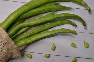 High angle view of green chili peppers on table