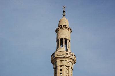 Low angle view of tower of building against blue sky