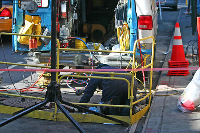 Manual worker working on road in city