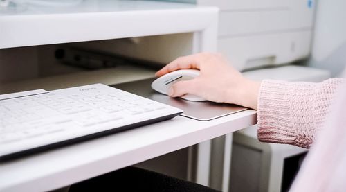 Close-up of woman reading book on table