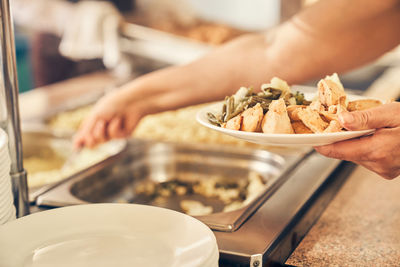 Midsection of person preparing food