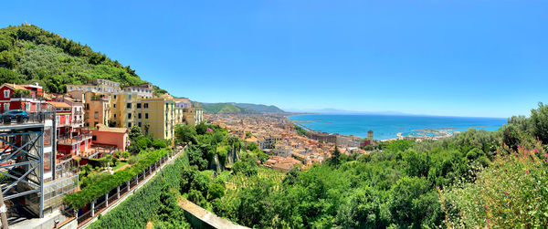 Scenic view of sea and mountains against blue sky