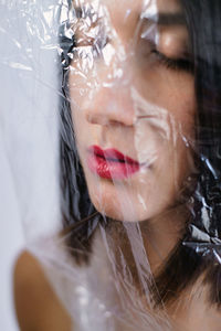 Portrait of attractive woman covered with plastic bag