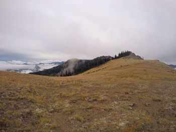Scenic view of mountains against cloudy sky