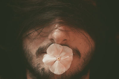 Close-up of woman with pink rose