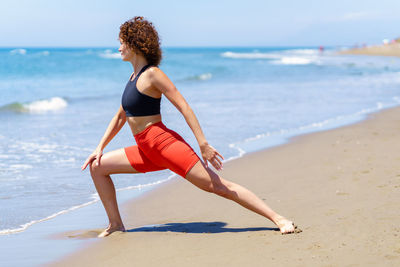 Full length of woman standing at beach