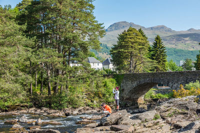 A couple of tourists taking pictures of falls of dochart