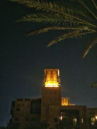 Low angle view of buildings against sky at night