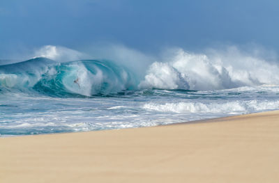 Scenic view of sea waves against sky