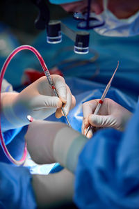 Midsection of surgeons performing surgery