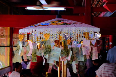 Paper currencies hanging on parasol in market