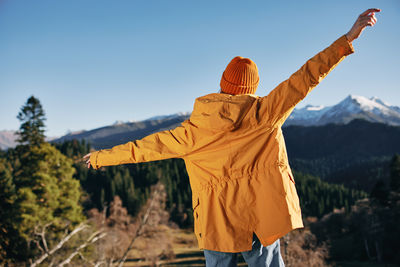 Rear view of man standing against sky