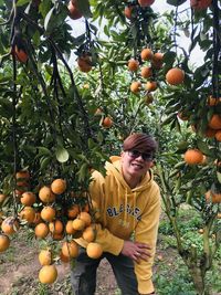 Full length of man against orange tree