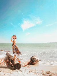 Woman on beach against sky