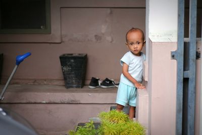 Cute boy standing at home