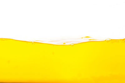Full frame shot of yellow water against white background
