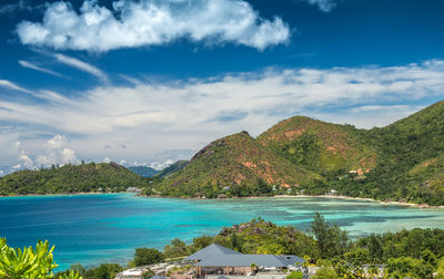 Scenic view of sea and mountains against sky