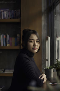 Young woman looking at table at home