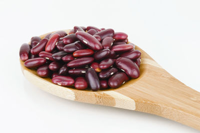 Close-up of roasted coffee beans against white background